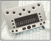 A BrailleConnect Refreshable Braille Display propped upright and sitting atop a Glass Desk