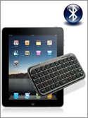 Photo of an Apple iPad connected to a small Bluetooth wireless QWERTY keyboard by the universal Bluetooth symbol.